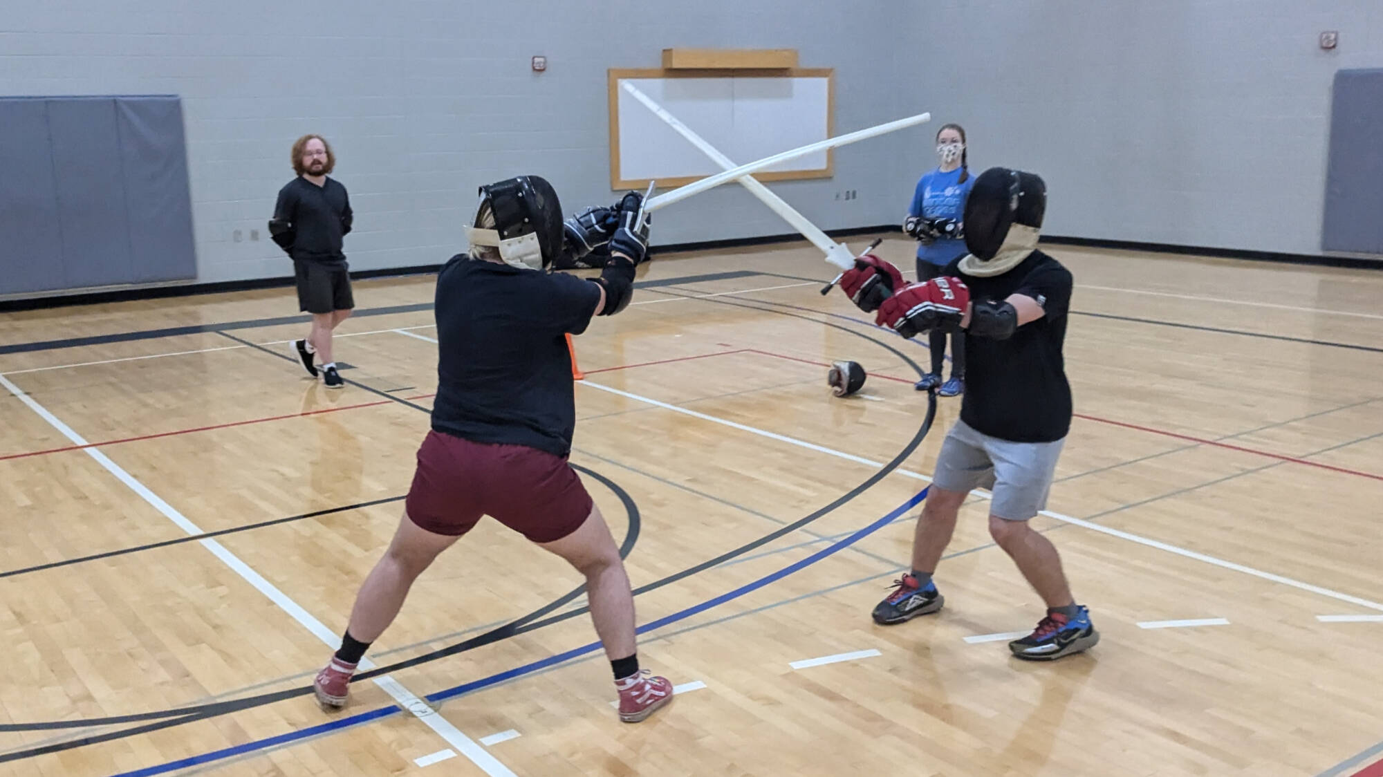 Students in FIT 115 sword fighting